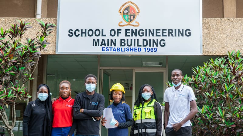 Zambia Flying Labs standing in front of the School of Engineering Building