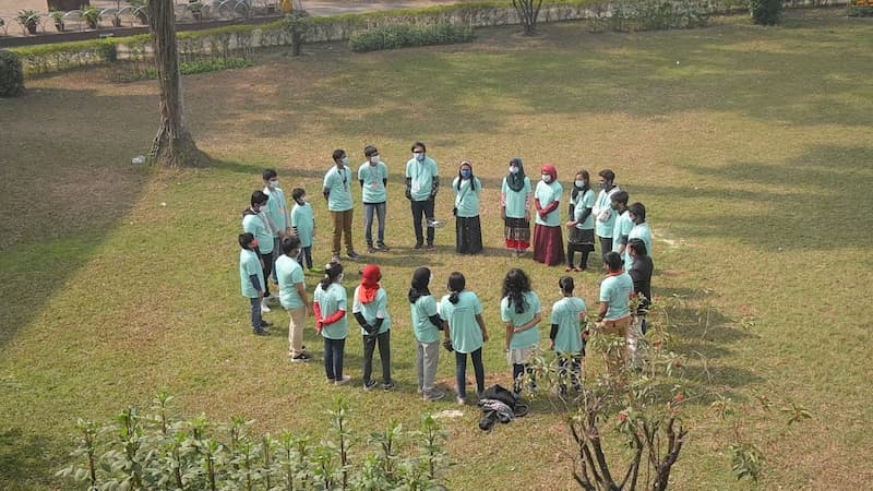Bangladesh Flying Labs STEM Program: A circle of students watch a drone take flight