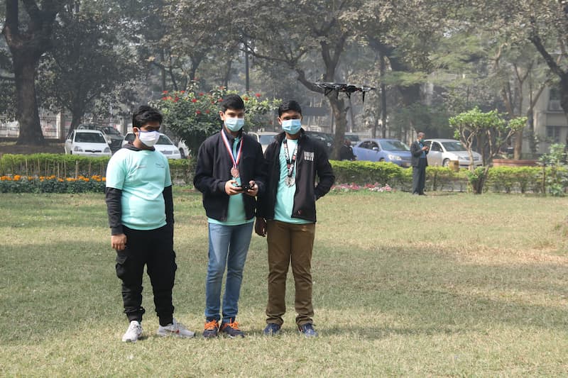Bangladesh Flying Labs STEM Program: A group of boys fly a drone